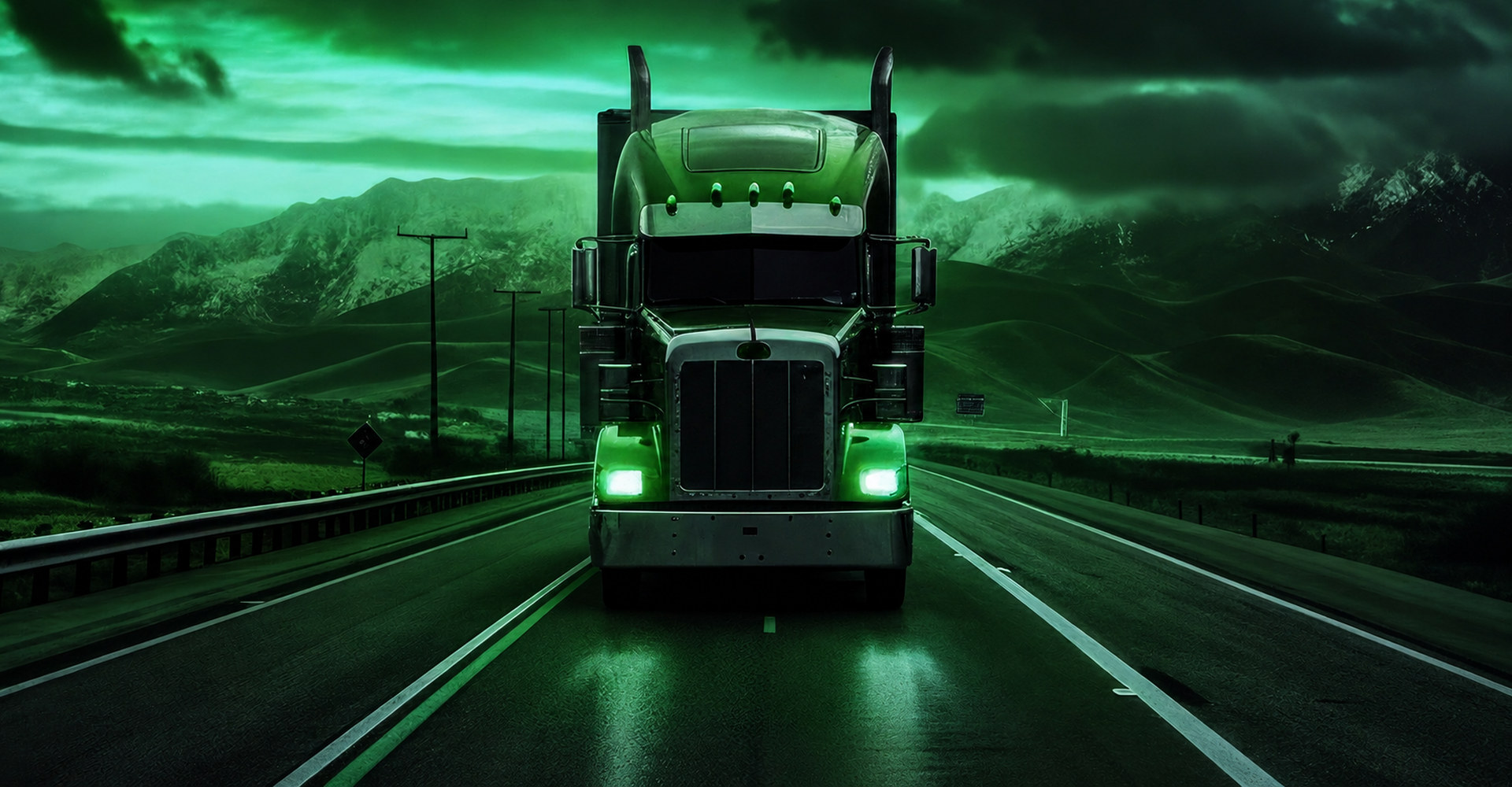 A tractor-trailer running a mountain highway at dusk